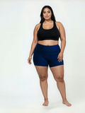 Swim Shorts | Plus Size shown on a curvy woman wearing navy swim shorts with a black swim top for modest supportive swimwear and a comfortable fit for every body