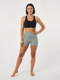 Woman wearing striped Swim Shorts with a comfortable fit and supportive modest design. Size-inclusive swimwear designed for every body.