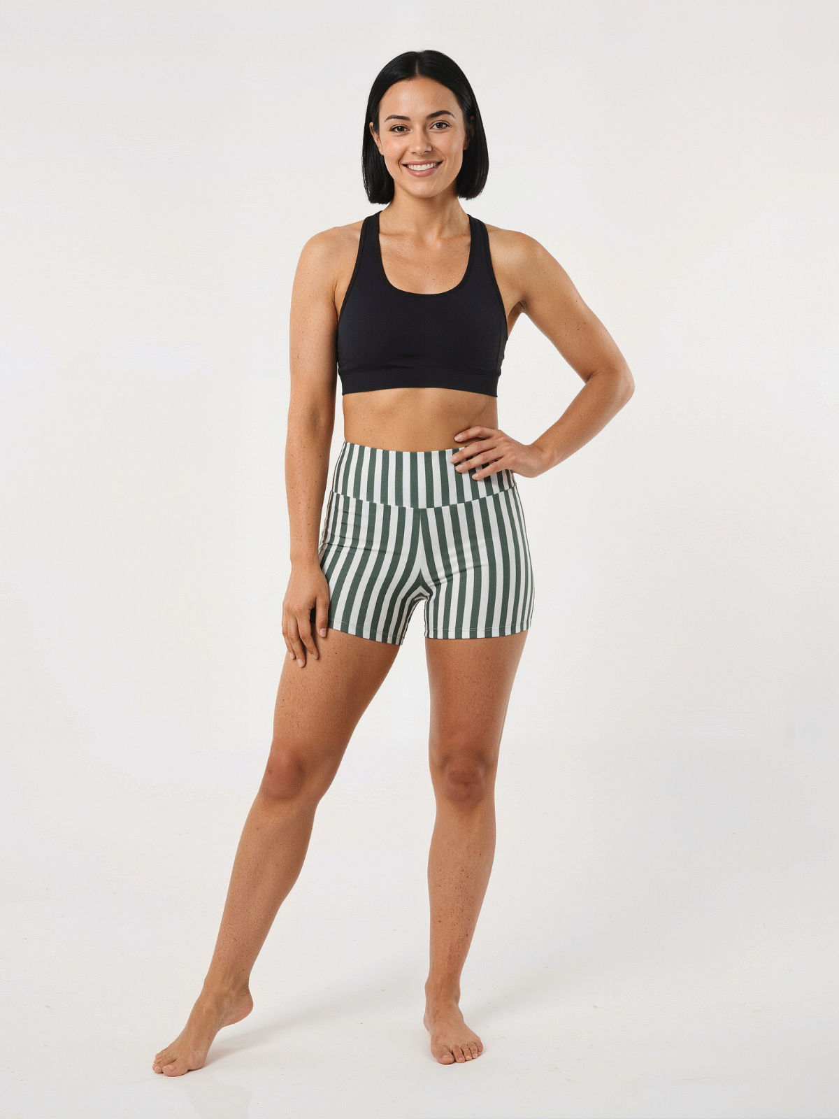 Woman wearing striped Swim Shorts with a comfortable fit and supportive modest design. Size-inclusive swimwear designed for every body.