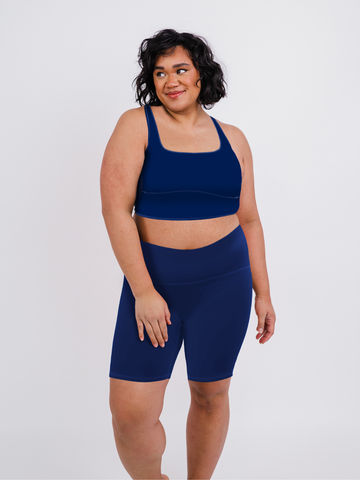 Woman wearing navy supportive long bike shorts paired with a matching swim top, highlighting Tummy Control Long Bike Swim Shorts | Plus Size, size-inclusive, modest swimwear with a comfortable fit for every body.