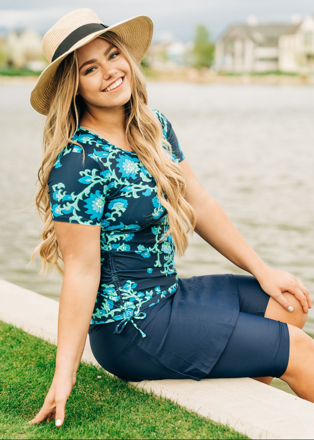 Woman wearing a blue and yellow patterned top on a white background