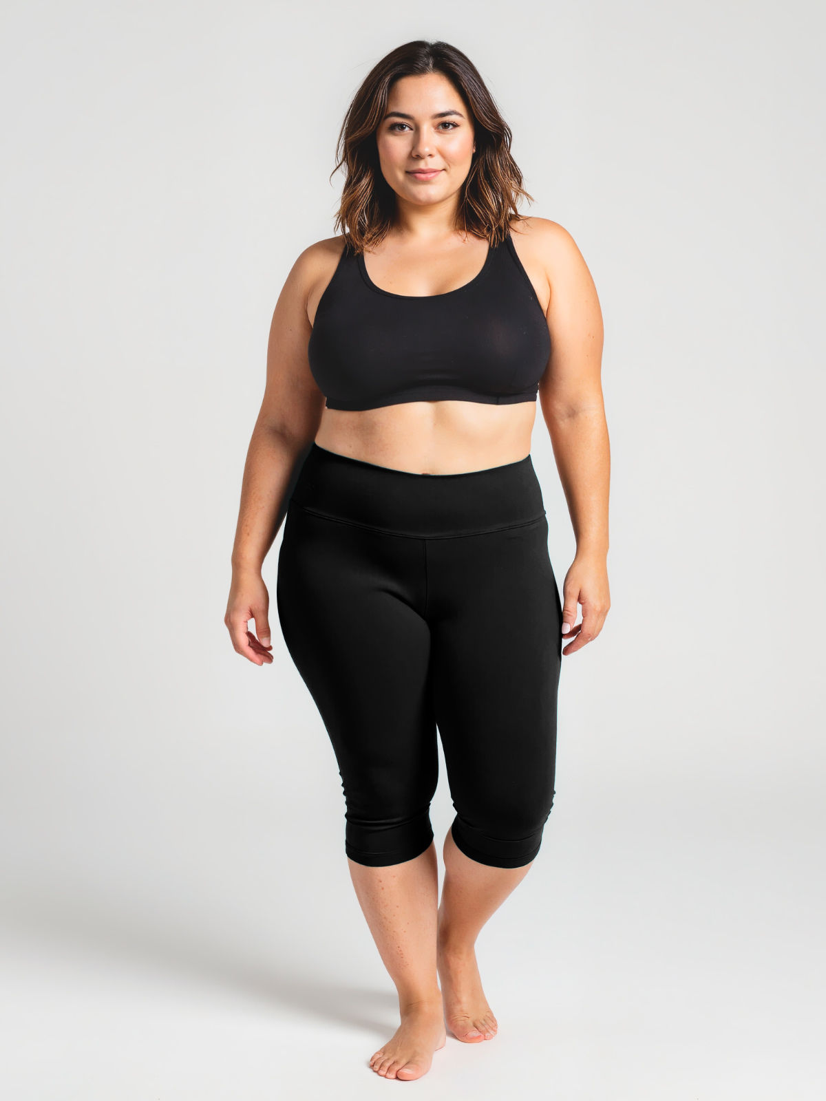 Plus size woman modeling black Capri Swim Leggings | Plus Size with a comfortable fit, supportive design, and modest coverage, promoting size-inclusive swimwear for every body.