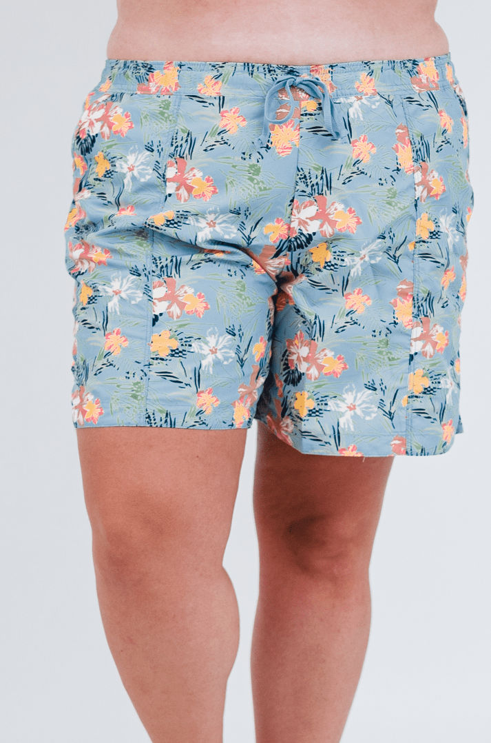 Colorful floral-patterned shorts worn by a person on a white background