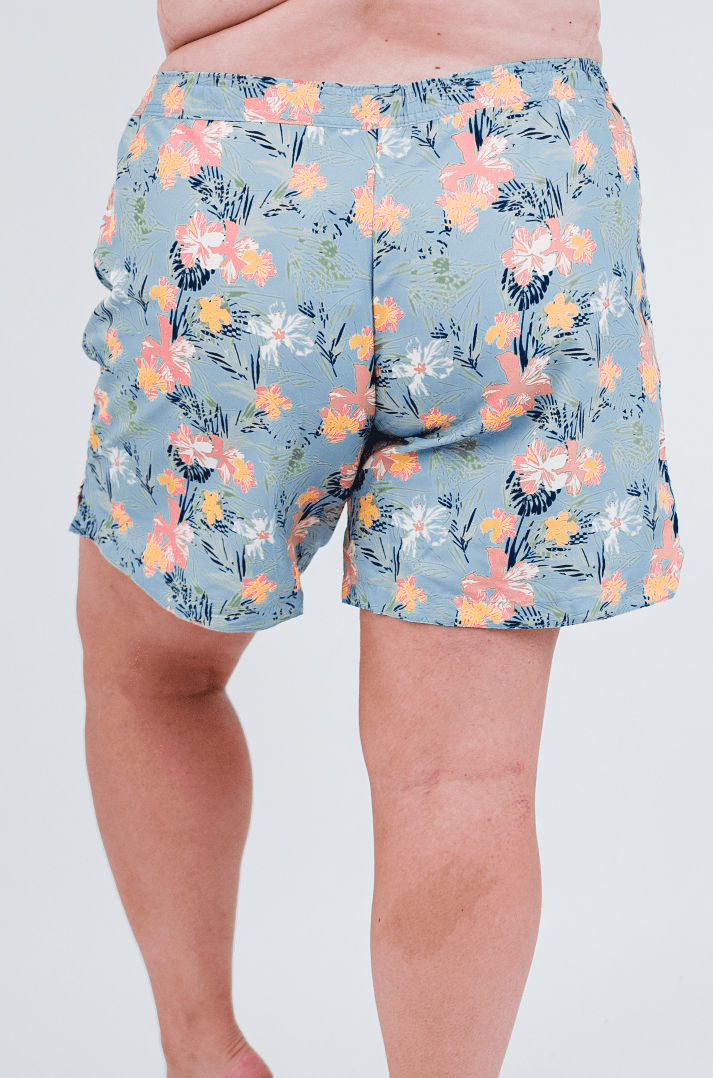 Colorful floral-patterned shorts worn by a person on a white background