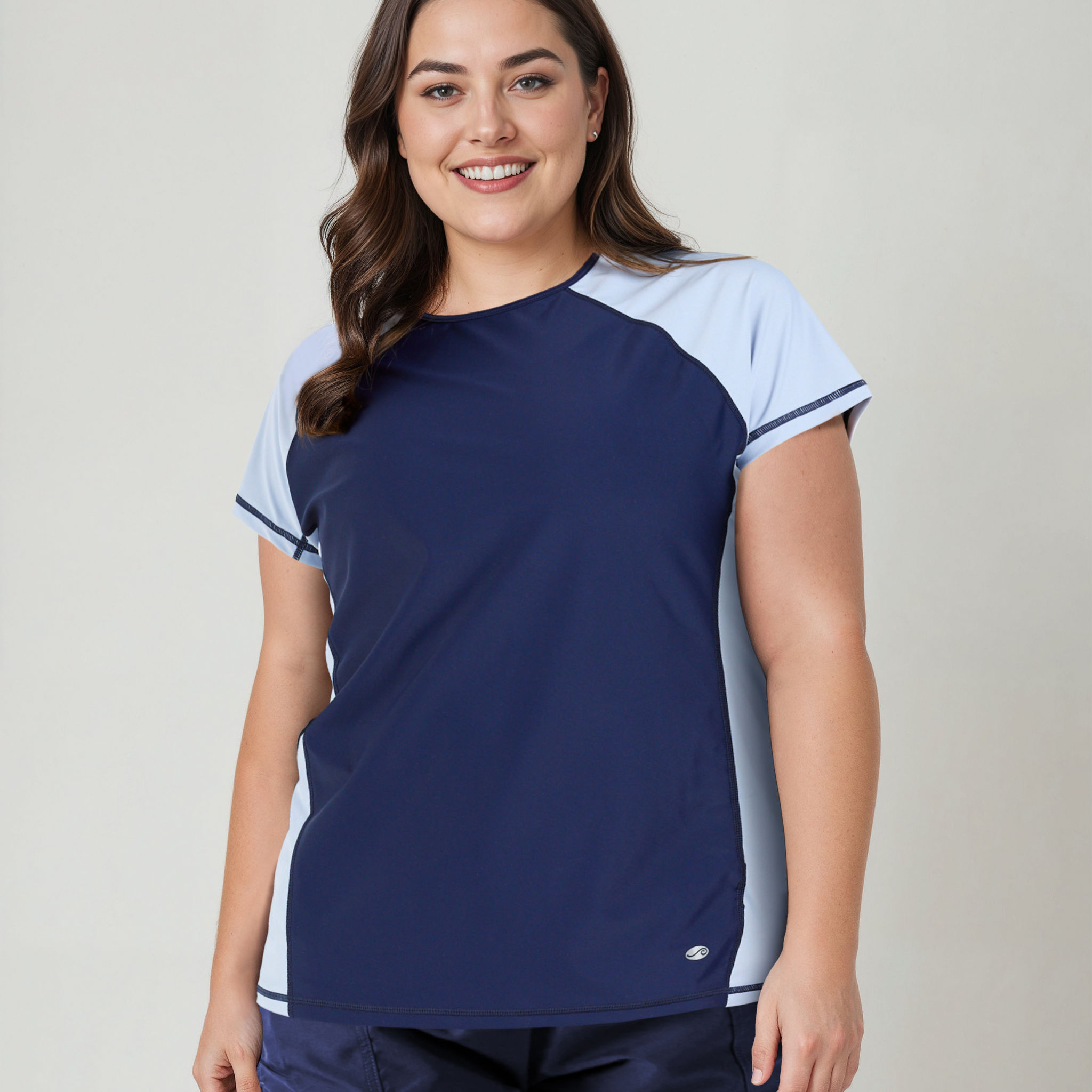 Woman wearing a navy and light blue athletic outfit on a plain background