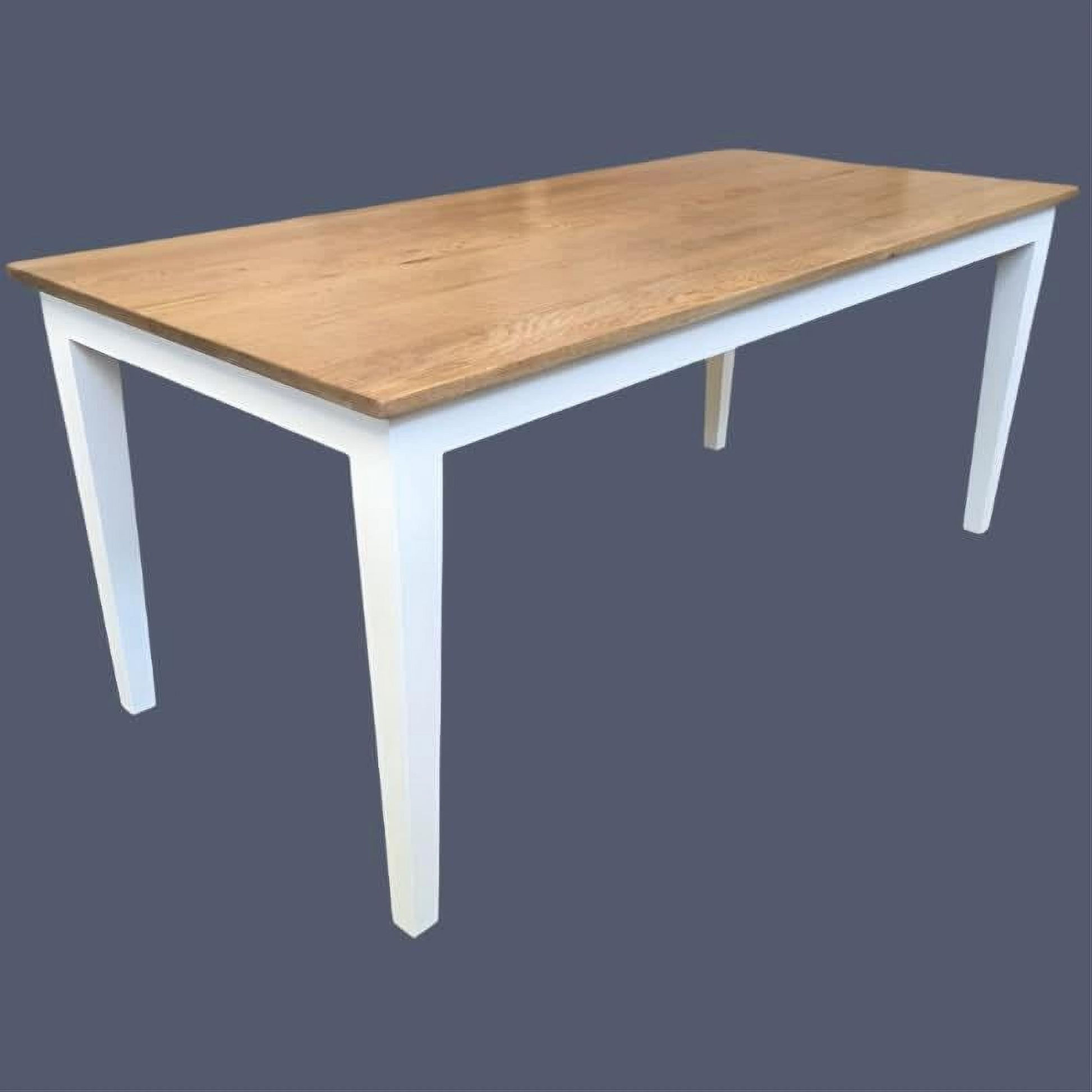 A rectangular dining table with a light natural oak wood top and white painted legs, shown against a solid dark slate gray background.