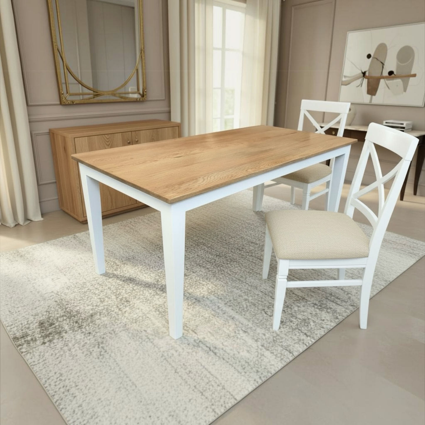 A rectangular dining table with a light oak wood top and white legs, accompanied by two white chairs with cream upholstered seats, set on a textured light gray rug in a bright, modern dining room.