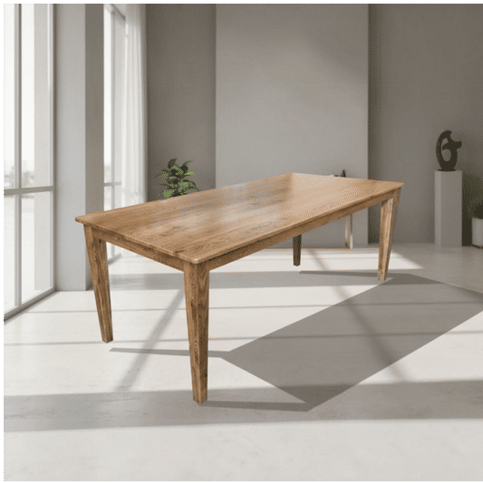 A rectangular wooden dining table with a natural oak finish and four tapered legs, shown in a modern minimalist room with gray walls and large windows.