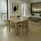 A light oak wood dining table with four matching wooden chairs in a bright, modern living room setting.