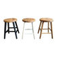 Three round wooden bar stools shown side by side on a plain white background, with different leg color options: black, white, and natural wood.