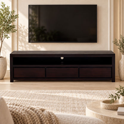 A dark wood TV stand with three drawers and an open shelf, styled in a modern living room setting under a wall-mounted television.