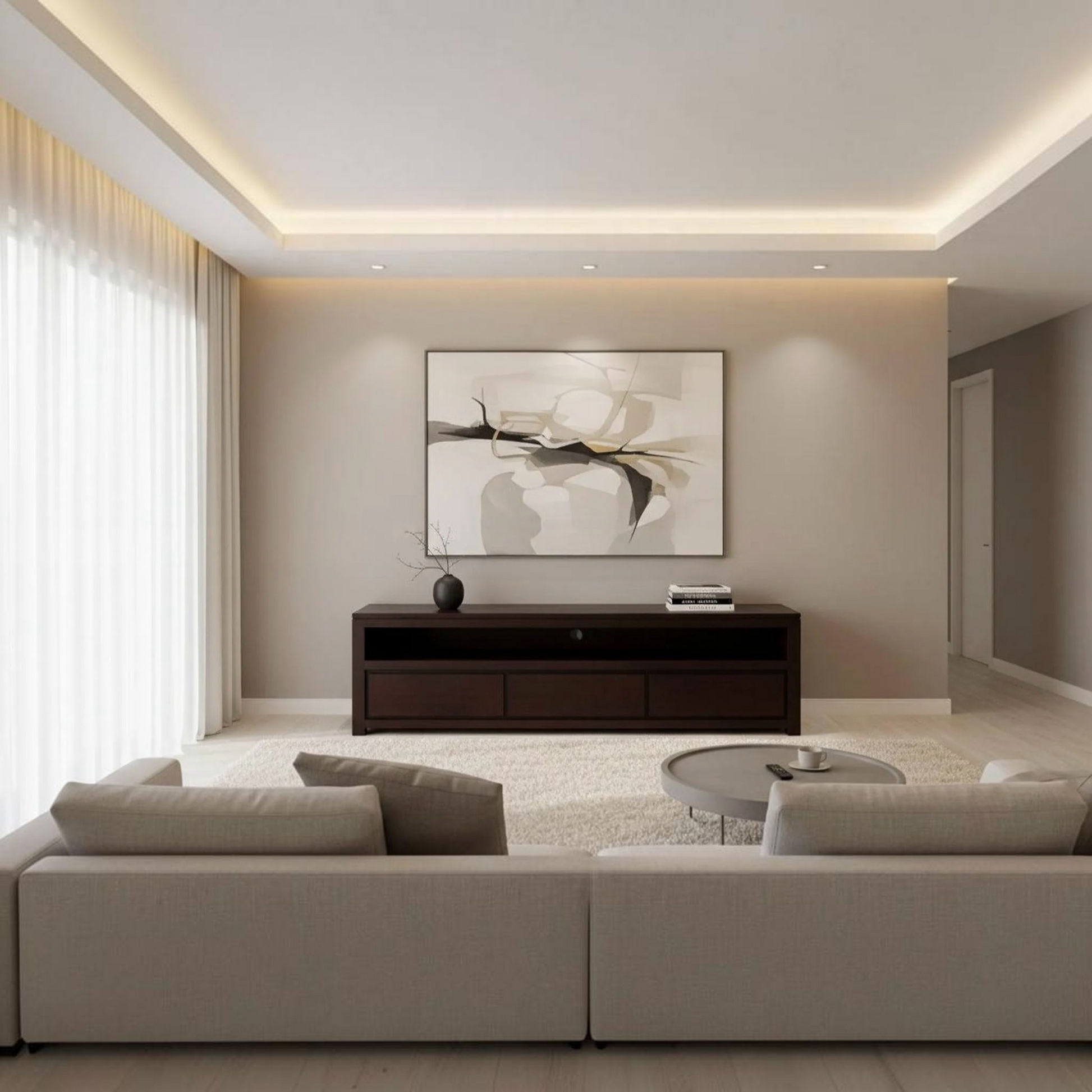 A modern living room with a large abstract art print hanging on a beige wall above a dark wood console table. The room features a light beige sectional sofa, a round glass coffee table, and a white shag rug, with soft natural light coming through sheer curtains on the left.