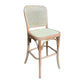 A classic bistro counter stool with a light natural wood frame and woven cane backrest and seat, isolated on a white background.