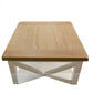 A square wooden coffee table with a light oak tabletop and a white painted frame featuring an X-shaped base, shown against a plain white background.