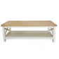 A rectangular coffee table with a light natural wood top and a white painted frame featuring an open lower shelf and X-shaped corner supports, shown against a plain white background.