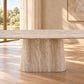 A modern dining table with a thick, textured beige stone pedestal base and a matching light wood tabletop, shown in a bright, sunlit room with warm neutral walls and wood flooring.