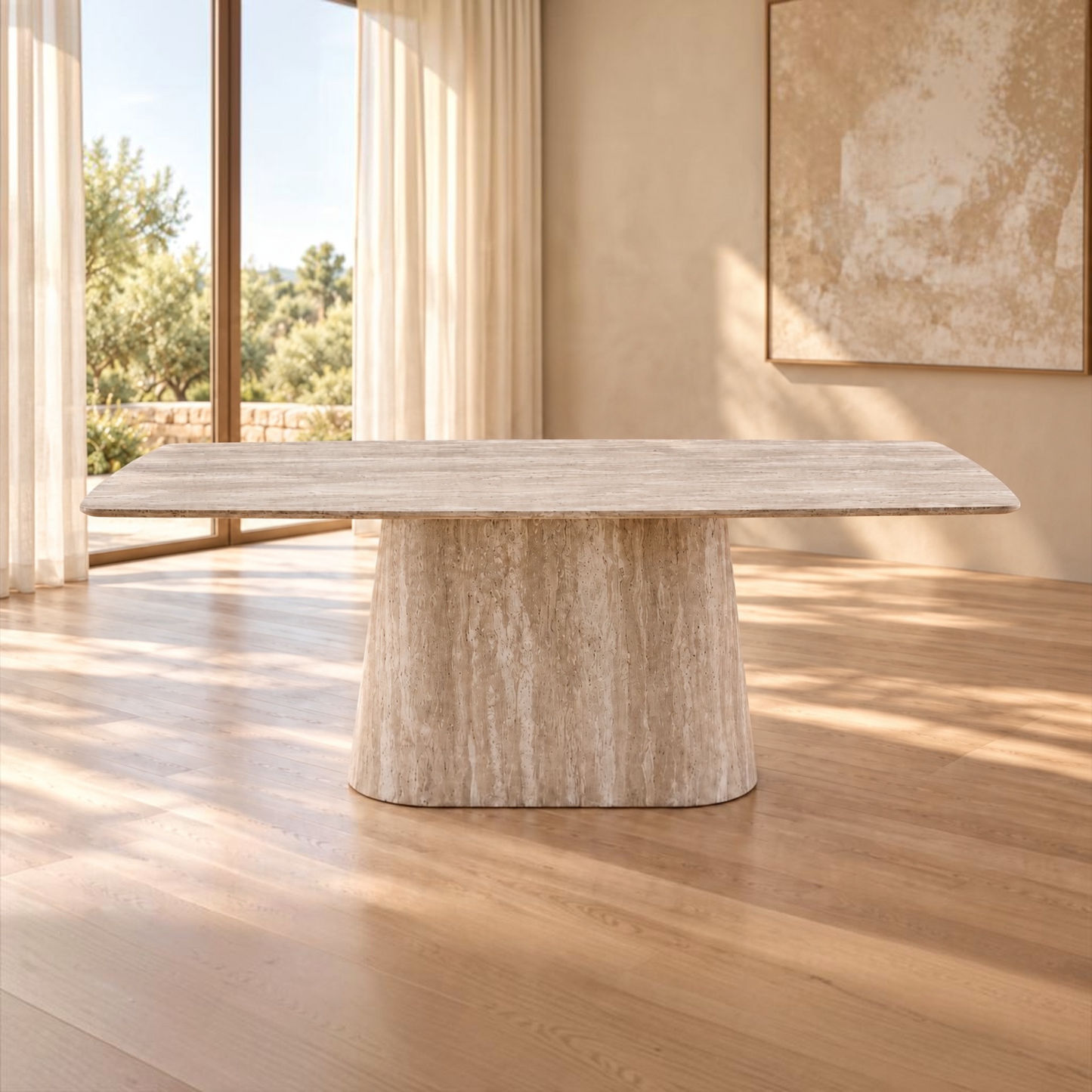 A rectangular dining table with a thick, sculptural pedestal base made of textured beige stone, set in a bright, modern room with light wood floors and warm neutral walls.