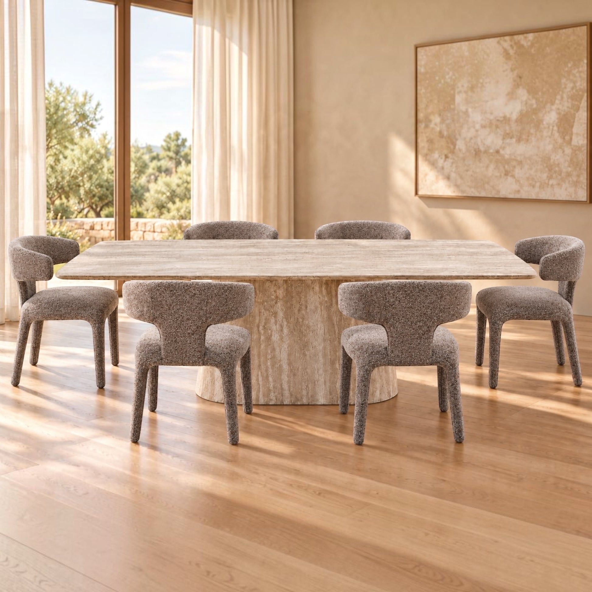 A modern dining set featuring a rectangular stone table and six upholstered dining chairs in a warm, sunlit room with wood floors and beige walls.