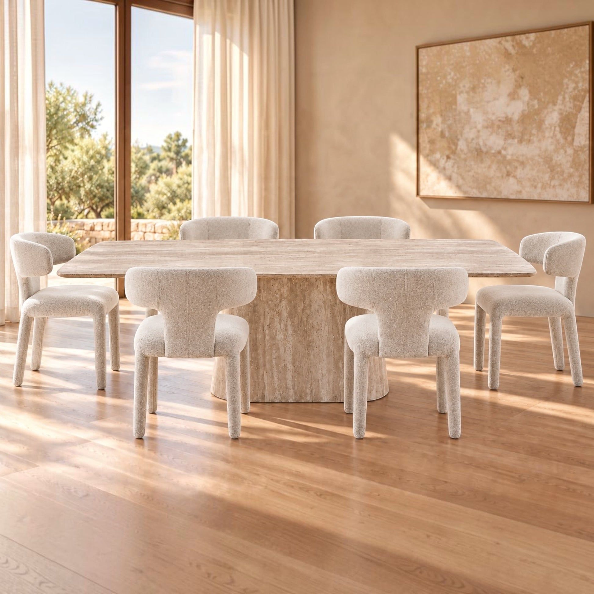 A modern dining set featuring a rectangular stone table and six matching upholstered chairs in a warm, sunlit room with wood floors and beige walls.