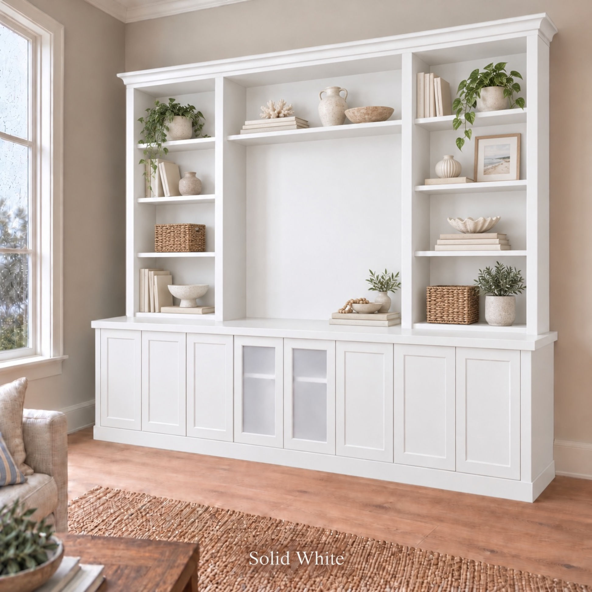 Harrington 5-piece wall unit in White, styled with books, vases and plants, angled view with frosted glass centre doors
