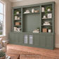 Harrington 5-piece wall unit in Dulux Mountain Camp, styled with books, vases and plants, angled view with frosted glass centre doors