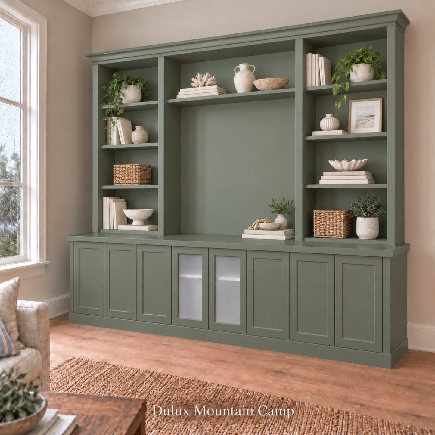 Harrington 5-piece wall unit in Dulux Mountain Camp, styled with books, vases and plants, angled view with frosted glass centre doors