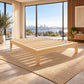Ferguson Bachelor Bed in NZ Pine – slatted base in a sunlit bedroom with city and water views