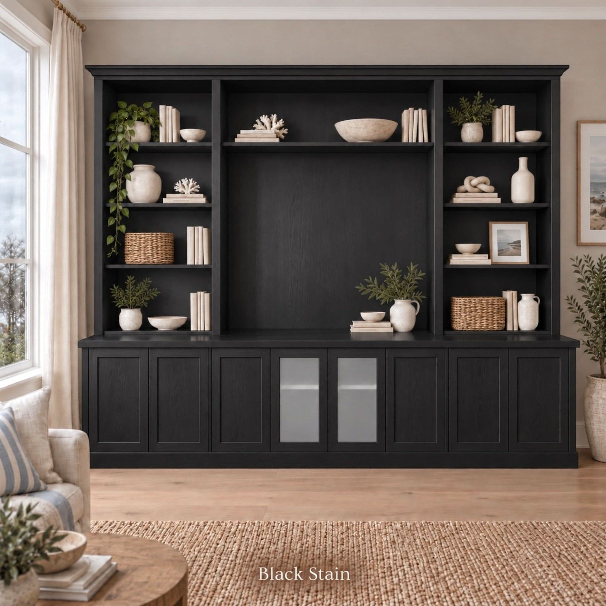 Harrington 5-piece wall unit in Black Stain, styled with books, vases and plants, front view with frosted glass centre doors