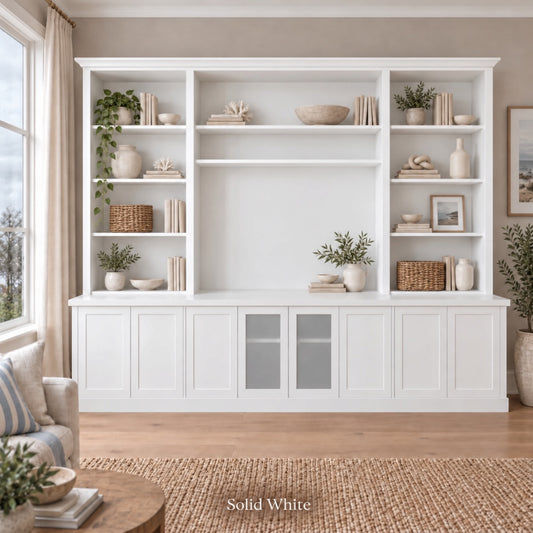 Harrington 5-piece wall unit with extra centre shelf in White, styled with books, vases and plants, front view with frosted glass centre doors