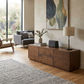 Gatsby Solid Mindi Timber 2-Door 2-Drawer TV Unit 190cm in Walnut, in a bright living room with a grey sofa and abstract artwork - Chocolate Wood