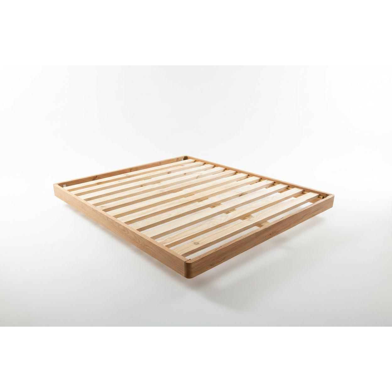 Solid VIC ash bed by Chocolate Wood with curved edges, floating legs, finished with Danish oil, made to order.