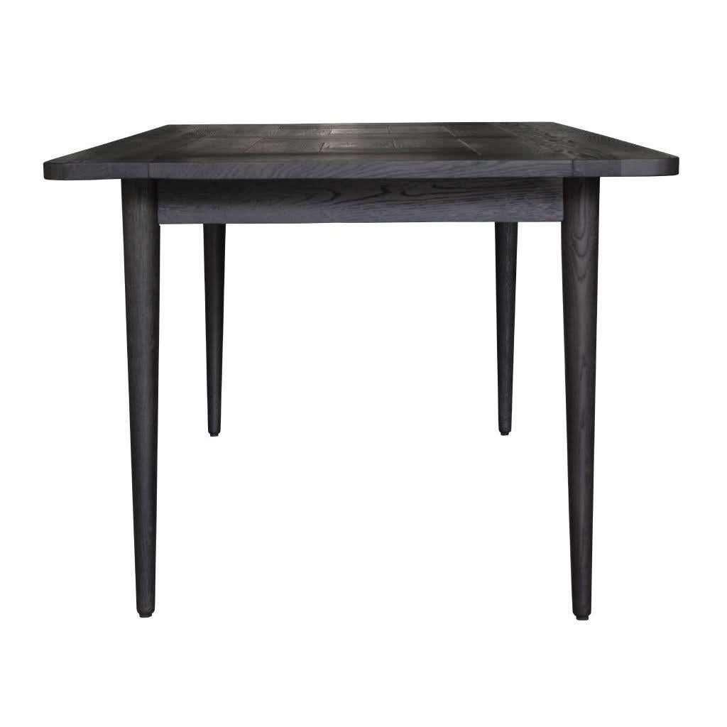 Sandblasted black oak Medrano dining table by MyChocolateWood, 180cm long, showcasing sleek modern design and textured surface.