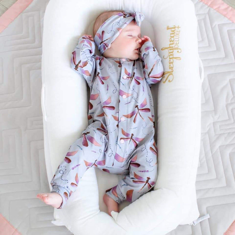 New Baby Girl wearing Dragonflies Romper and Headband set By Lottie & Lysh. Sleeping in a Sleepyhead pod.