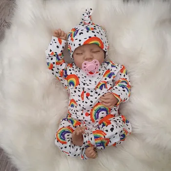 rainbow baby clothing by Lottie & Lysh. Rainbow poppered romper with matching knotted baby hat.