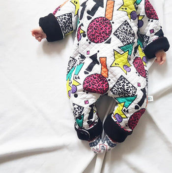 colourful baby clothes collection by Lottie & Lysh. 80s inspired printed baby and toddler pramsuit lined with black fleece