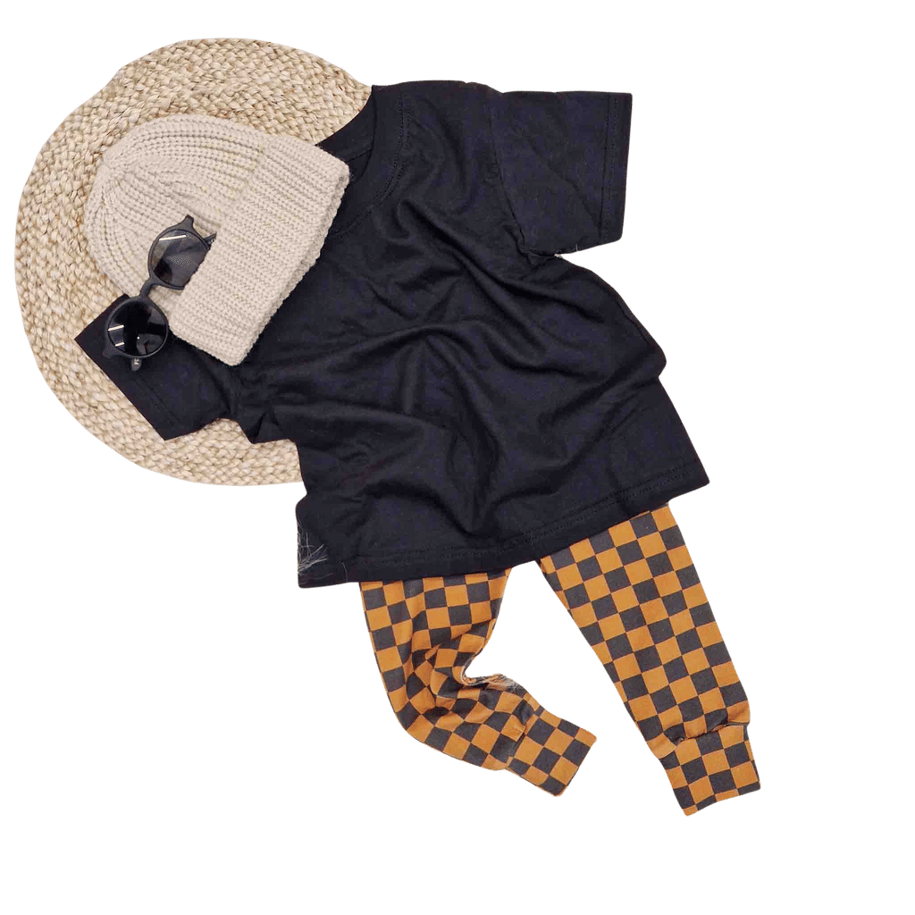 toddler boy clothes - Lottie & Lys checkbouard boys leggings, black t-shirt and beige knitted beanie hat flat lay image