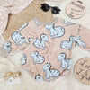 beige sweater romper for babies and toddlers featuring a cute blue dinosaur motif