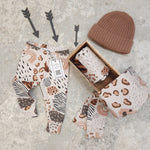 handmade leggings featuring various animal prints and weather elements such as rain drops and rainbows, in a neutral colourway