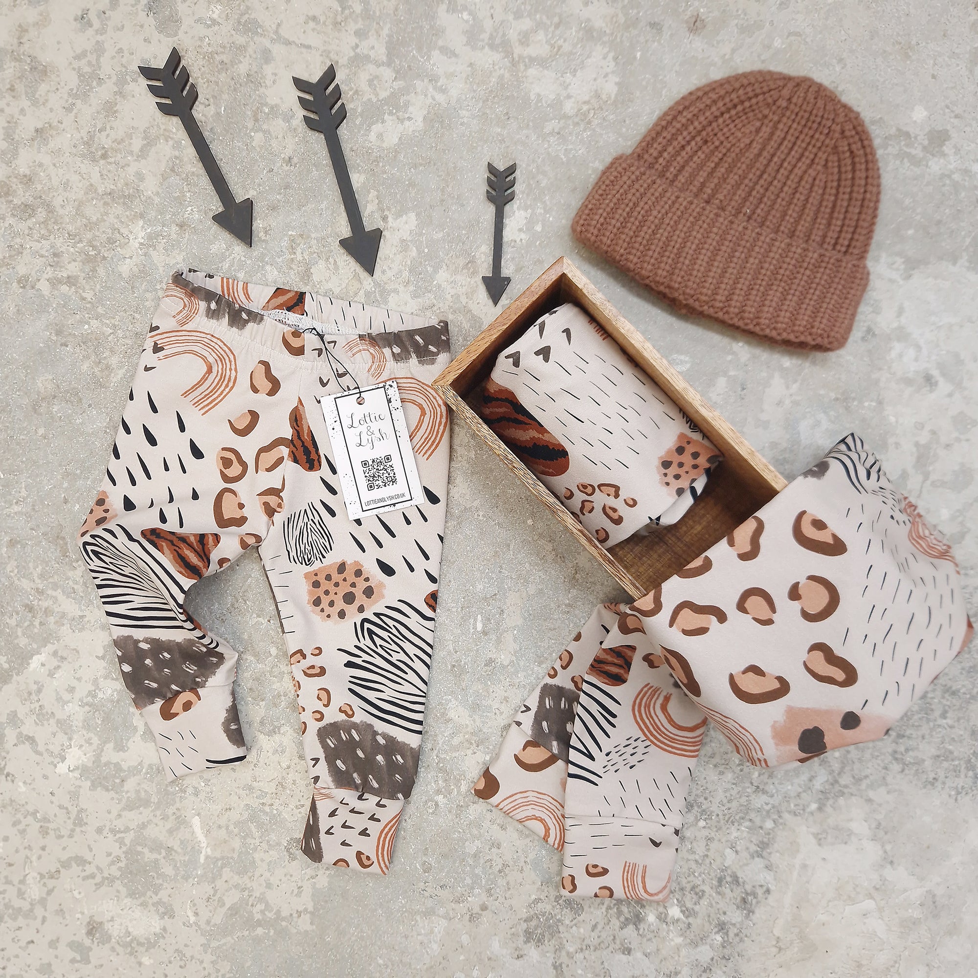 handmade leggings featuring various animal prints and weather elements such as rain drops and rainbows, in a neutral colourway