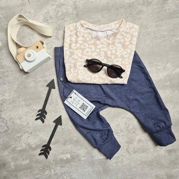 kids outfit featuring a beige leopard print t-shirt and blue trousers