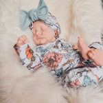 floral printed baby grow with matching bow hat

