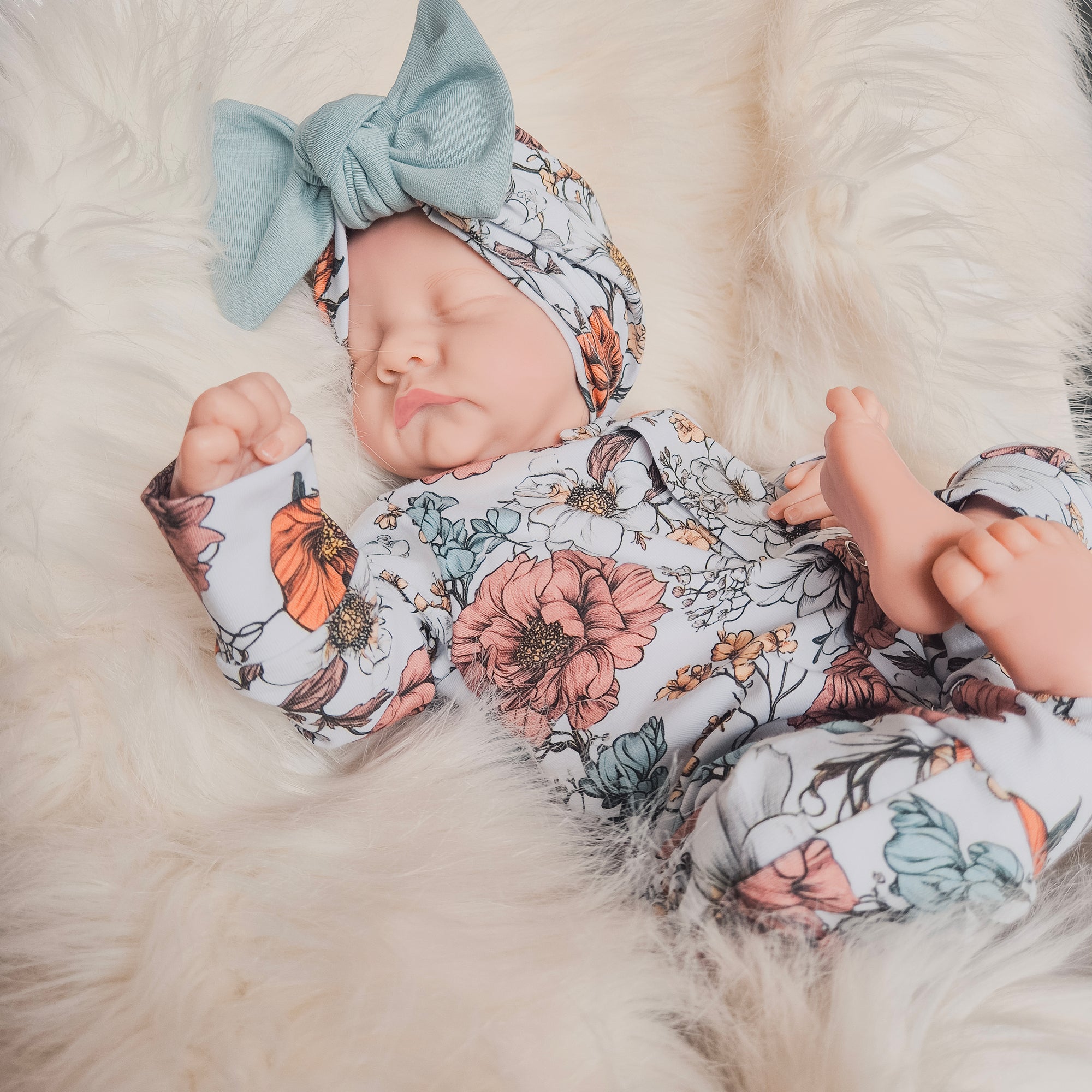 floral printed baby grow with matching bow hat