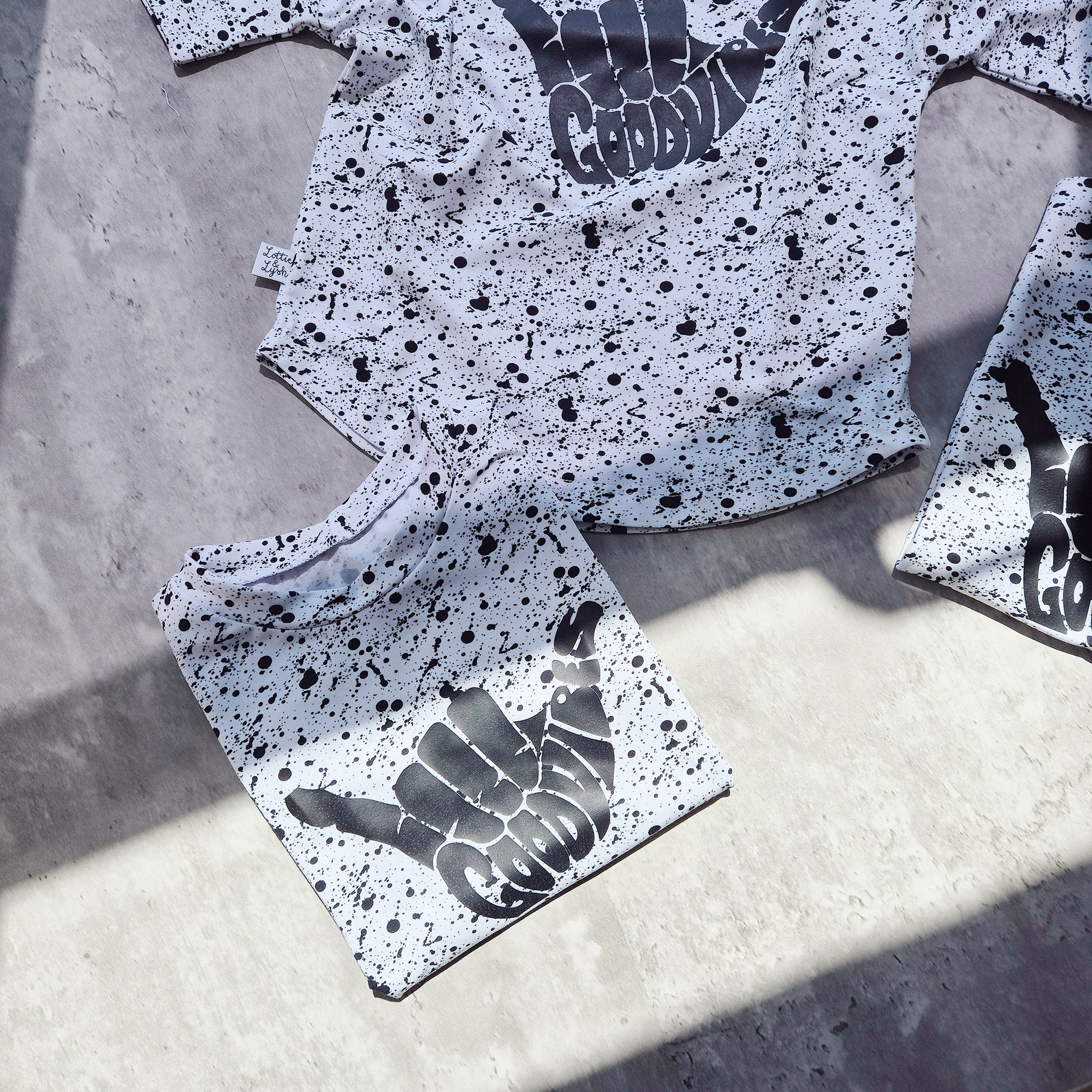 Detailed view of Good Vibes hand sign print on children’s white T-shirt. Sustainable long-lasting  printing techniques.