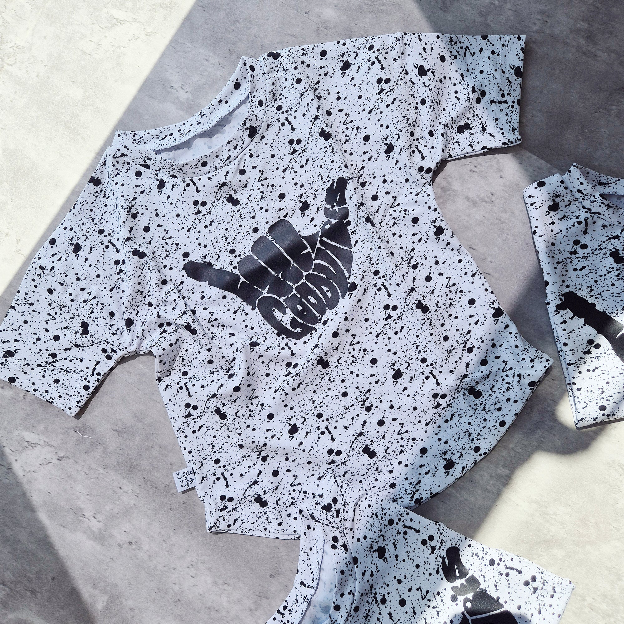 loose-fit Monosplatter tee with dipped hem. Ethically made in the UK, perfect for summer play.