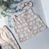 Flat lay image a kids oversized jersey waistcoat with white flower pattern. Handmade in the UK by Lottie & Lysh
