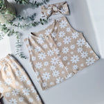 Flat lay image a kids oversized jersey waistcoat with white flower pattern. Handmade in the UK by Lottie & Lysh
