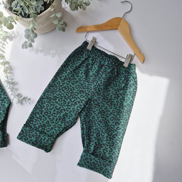 Flat lay image of green and black baggy trousers for kids