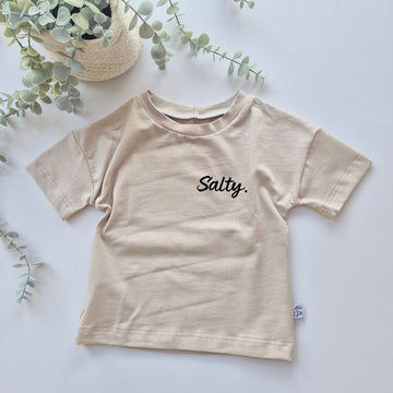 Kids beige oversized t-shirt featuring the word Salty. 