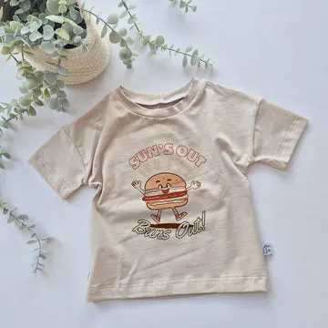 Beige t-shirt with a cartoon burger design and text on a light background