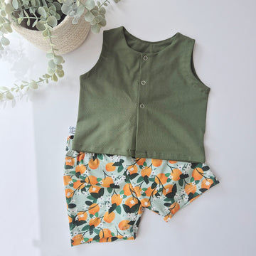 Green sleeveless top and floral shorts set on a white background